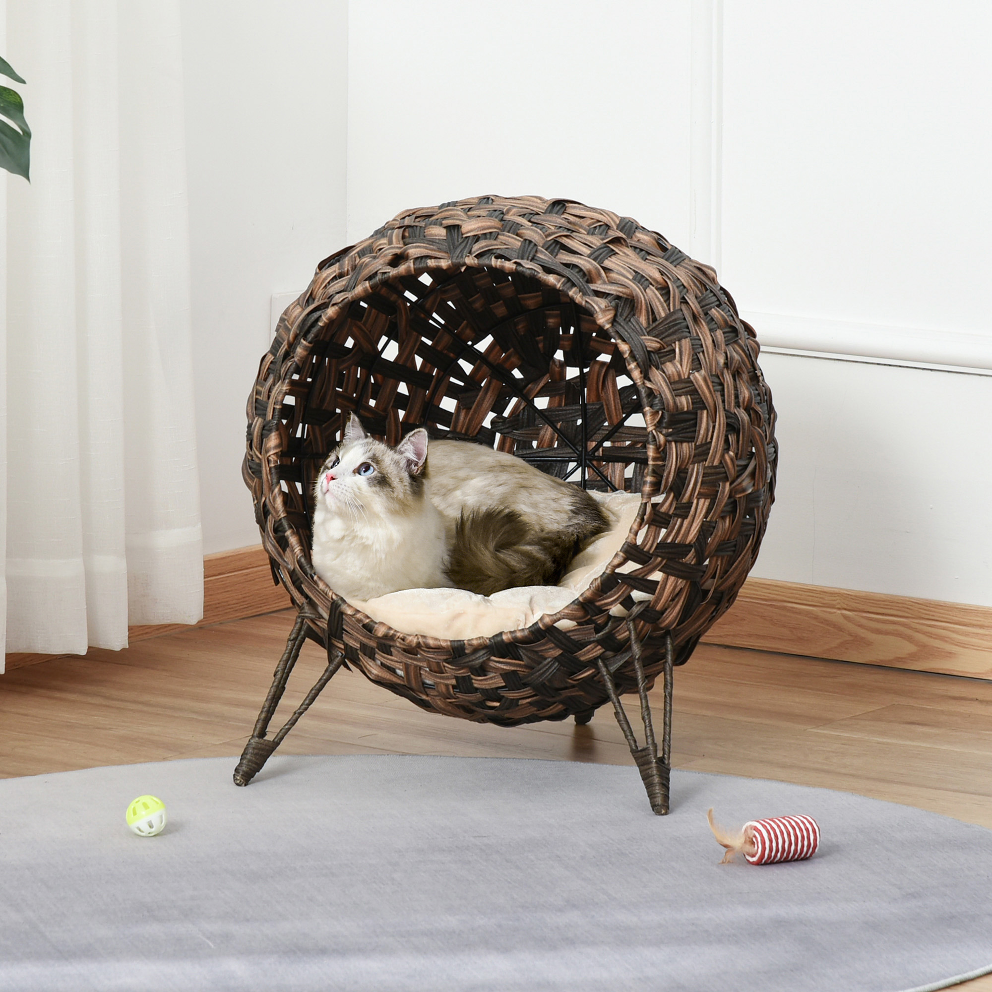 Elevated wicker cat bed for indoor cats with cushion and enclosed design